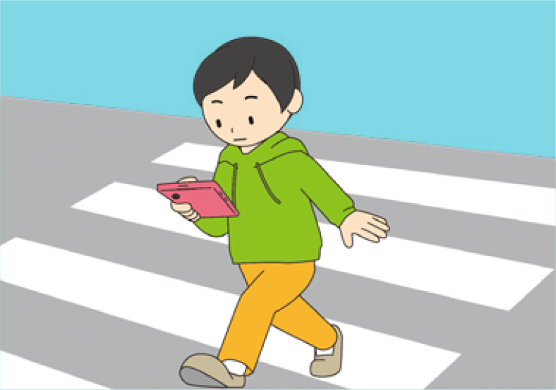 男の子横断歩道でスマホを見ている